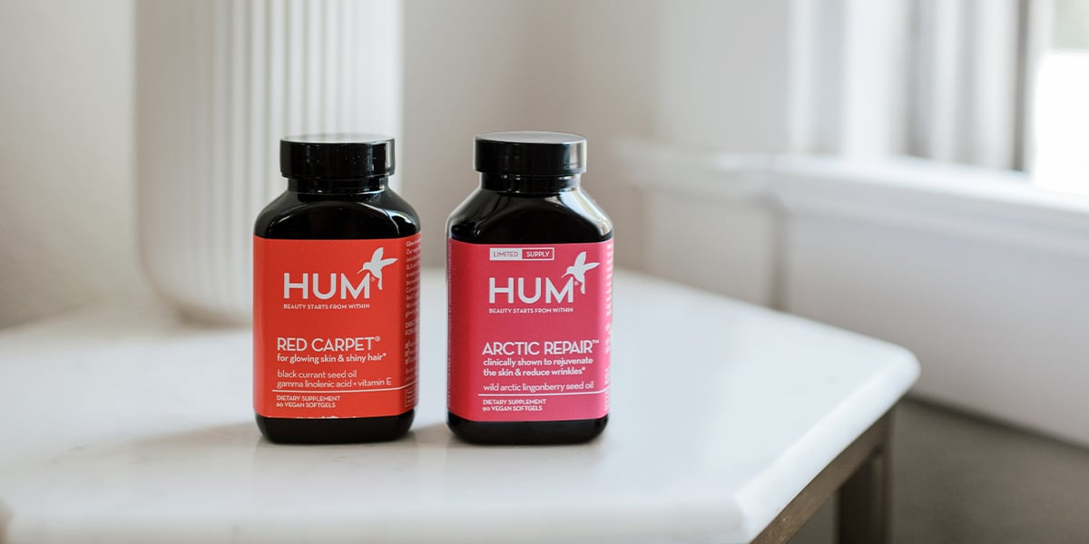 Two HUM Nutrition products sit on a countertop.